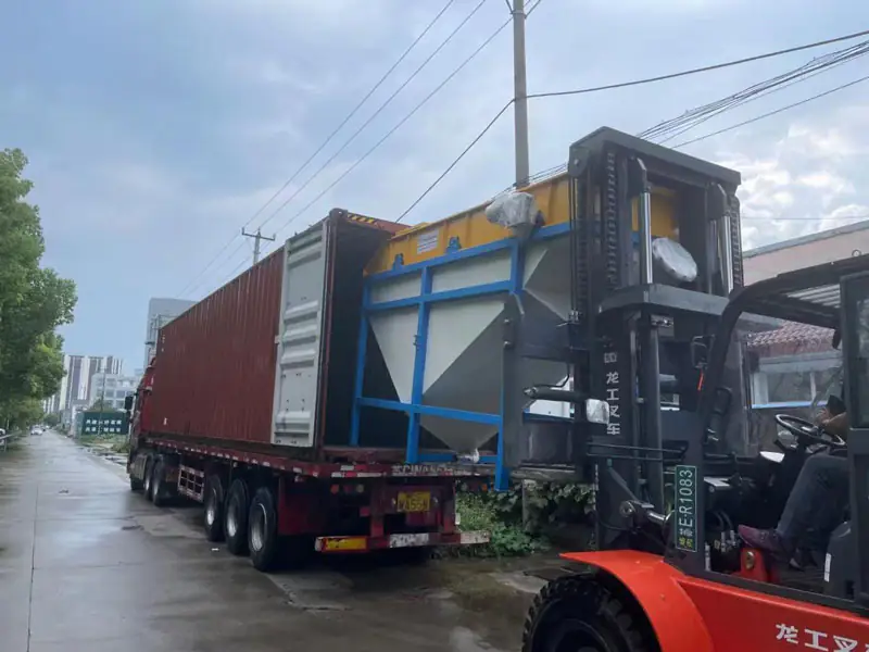 Forklift loading a large industrial machine onto a shipping container