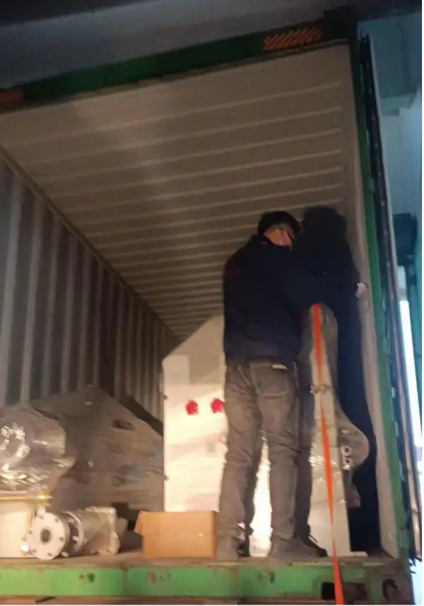 Worker securing machinery inside a shipping container