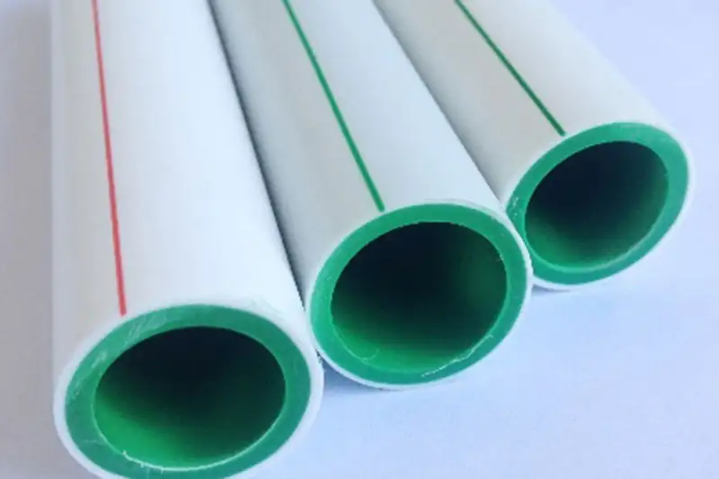 White plastic pipes with green inner layers