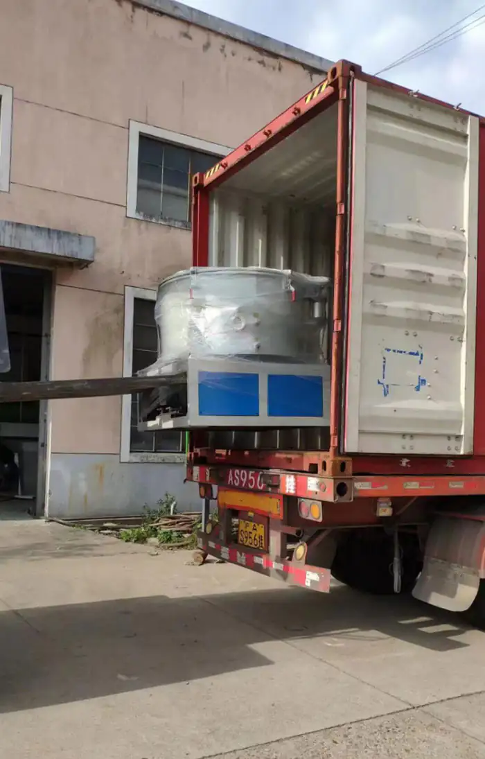 Wrapped industrial machinery being loaded into a shipping container